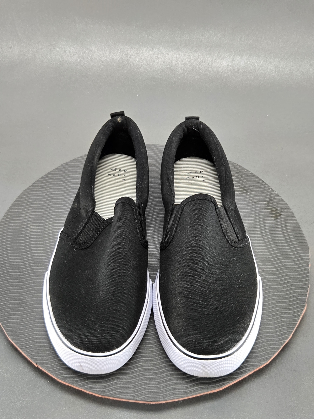 a new day Kids Black Slip-On Sneakers with White Sole